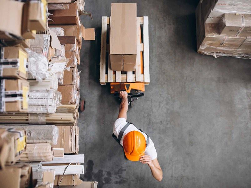 young-man-working-at-warehouse-with-boxes